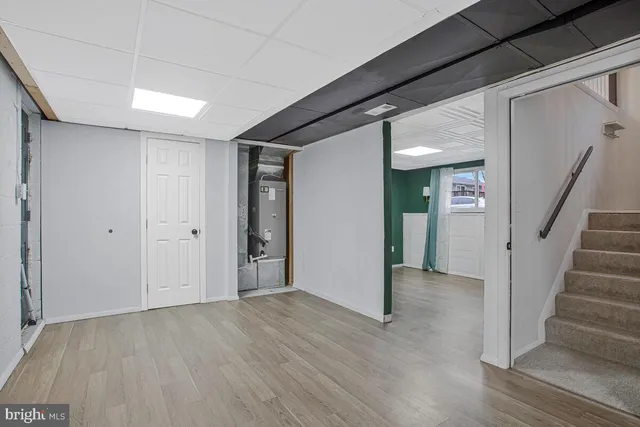 an empty room with wooden floor and closet