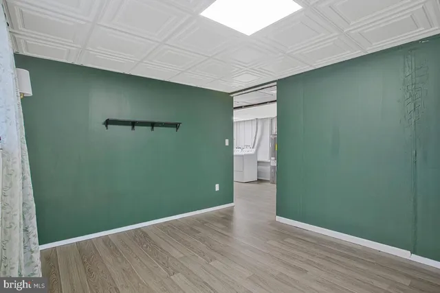 a view of a white house with a yard