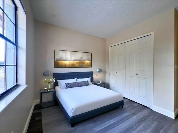 a bedroom with a bed and a flat screen tv