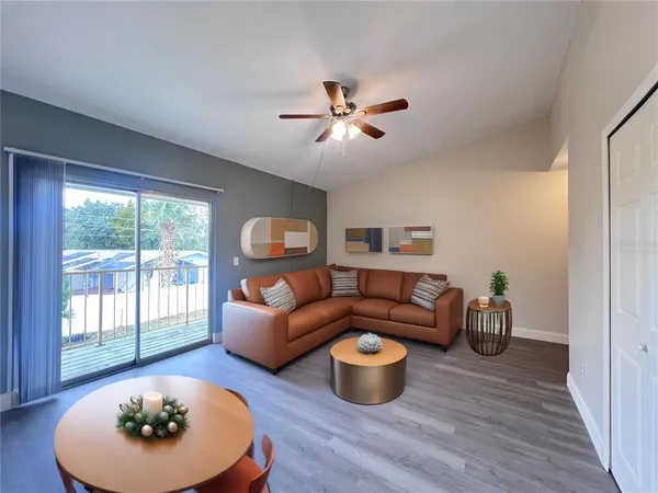 a living room with furniture a rug and a window