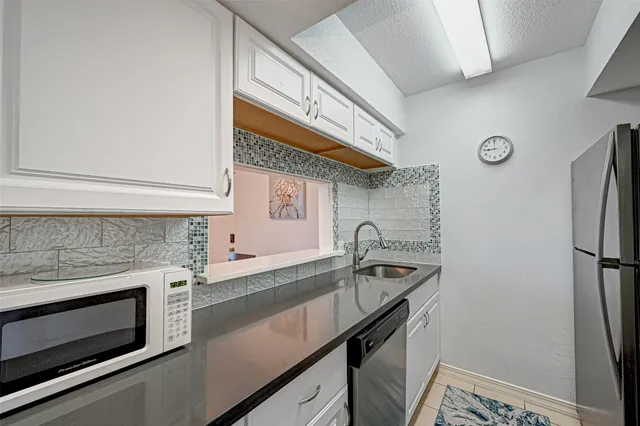 a kitchen with stainless steel appliances a sink stove and refrigerator