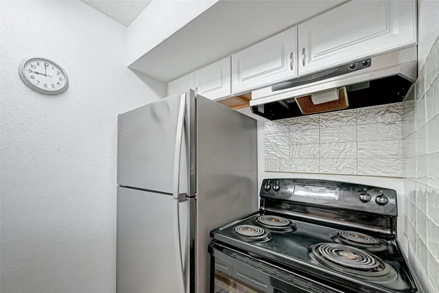 a kitchen with a stove and a refrigerator