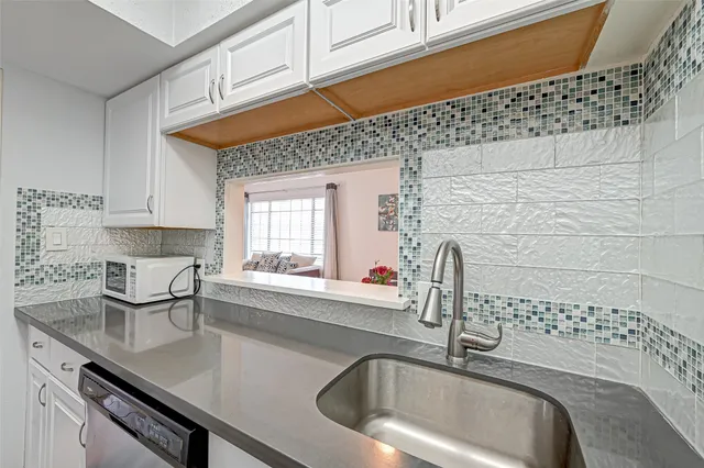 a kitchen with a sink and cabinets