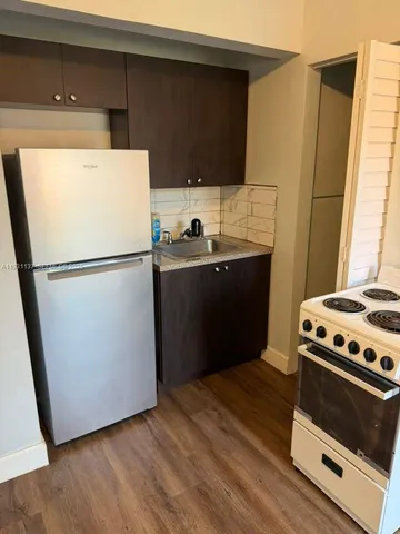 a kitchen with a refrigerator stove and sink