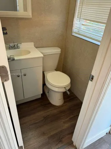 a white toilet sitting next to a bathroom sink