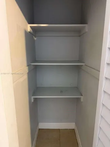 a view of walk in closet with empty racks