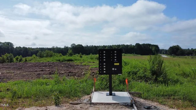 a view of a street with a house in the background