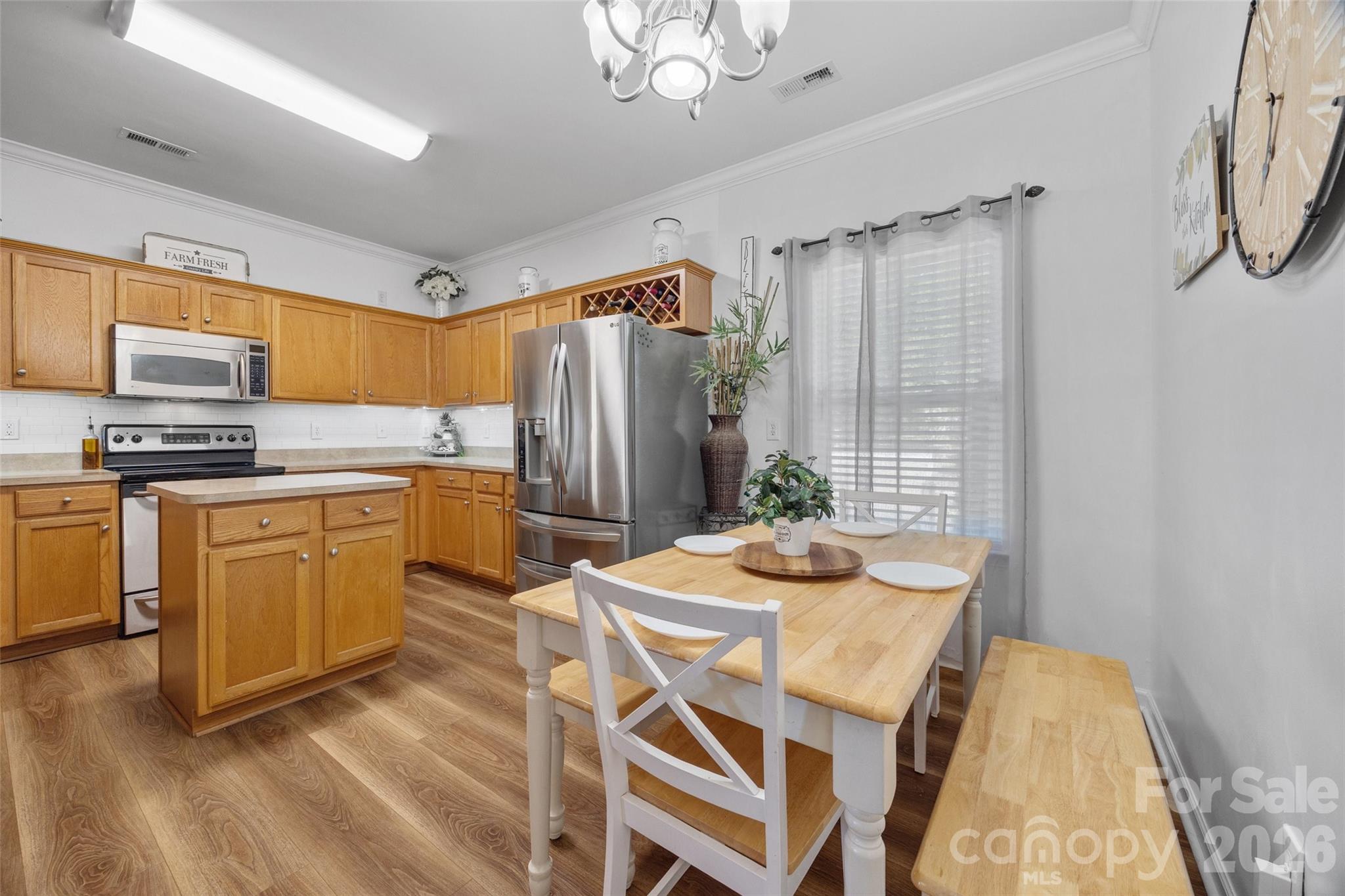 3419 Pickney Bluff Fort Mill, SC 29715 - Photo 11 of 36 a kitchen that has a stove a table and chairs in it