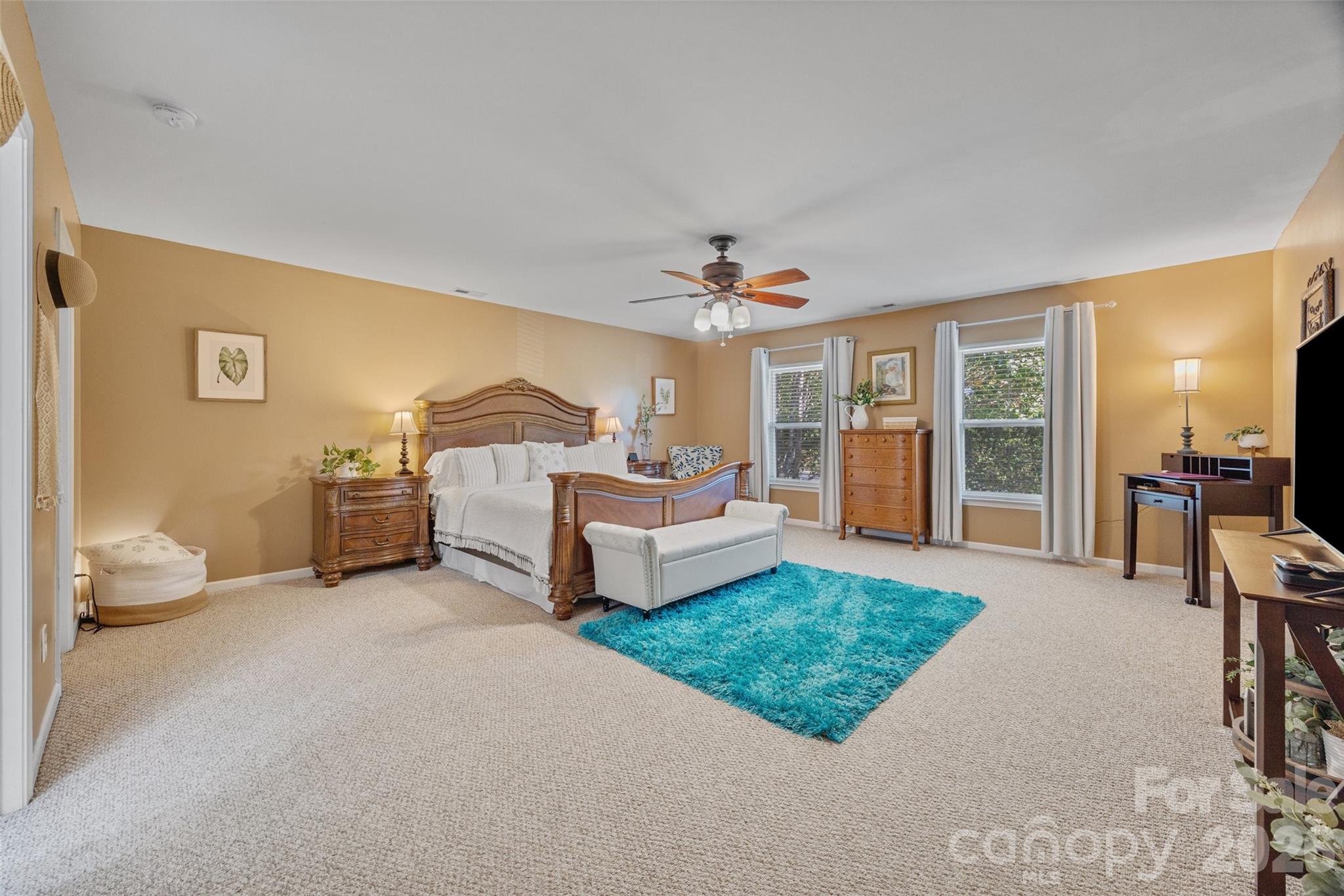 3419 Pickney Bluff Fort Mill, SC 29715 - Photo 19 of 36 a spacious bedroom with a bed a table and large window
