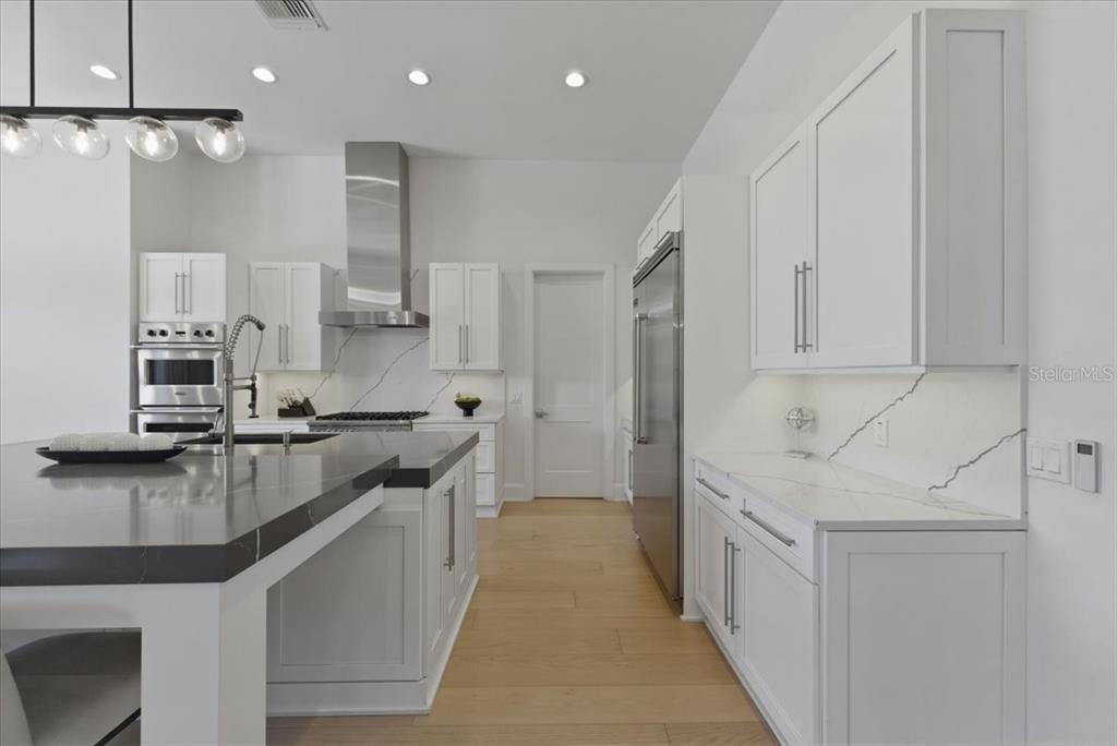 2829 Coastal Range Way Lutz, FL 33559 - Photo 23 of 64 a kitchen with stainless steel appliances granite countertop a sink a stove and a refrigerator