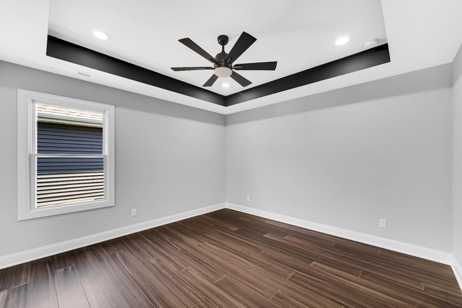 11039 Macedon Street Winfield, IN 46307 - Photo 21 of 36 a view of empty room with wooden floor and fan