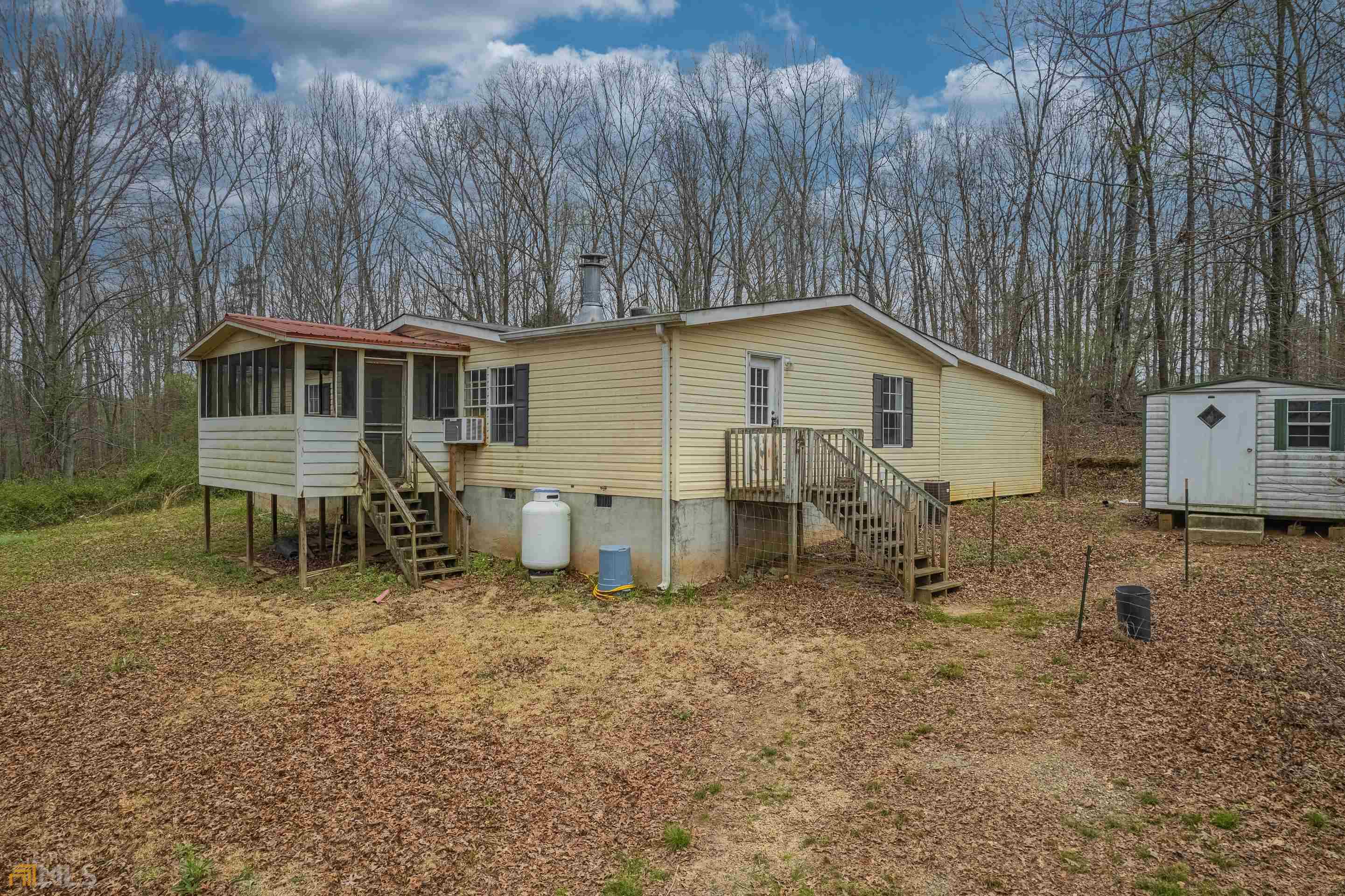 2629 Cole Road Carnesville, GA 30521 - Photo 1 of 1 a view of a house with a yard and a wooden fence