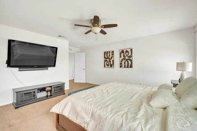 a spacious bathroom with a double vanity sink and a mirror