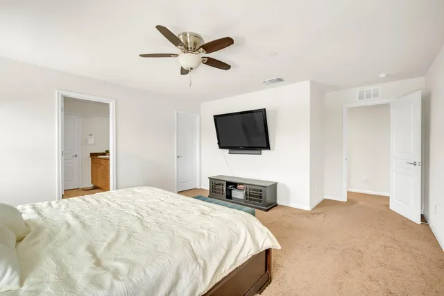 a spacious bathroom with a granite countertop sink a mirror and a shower