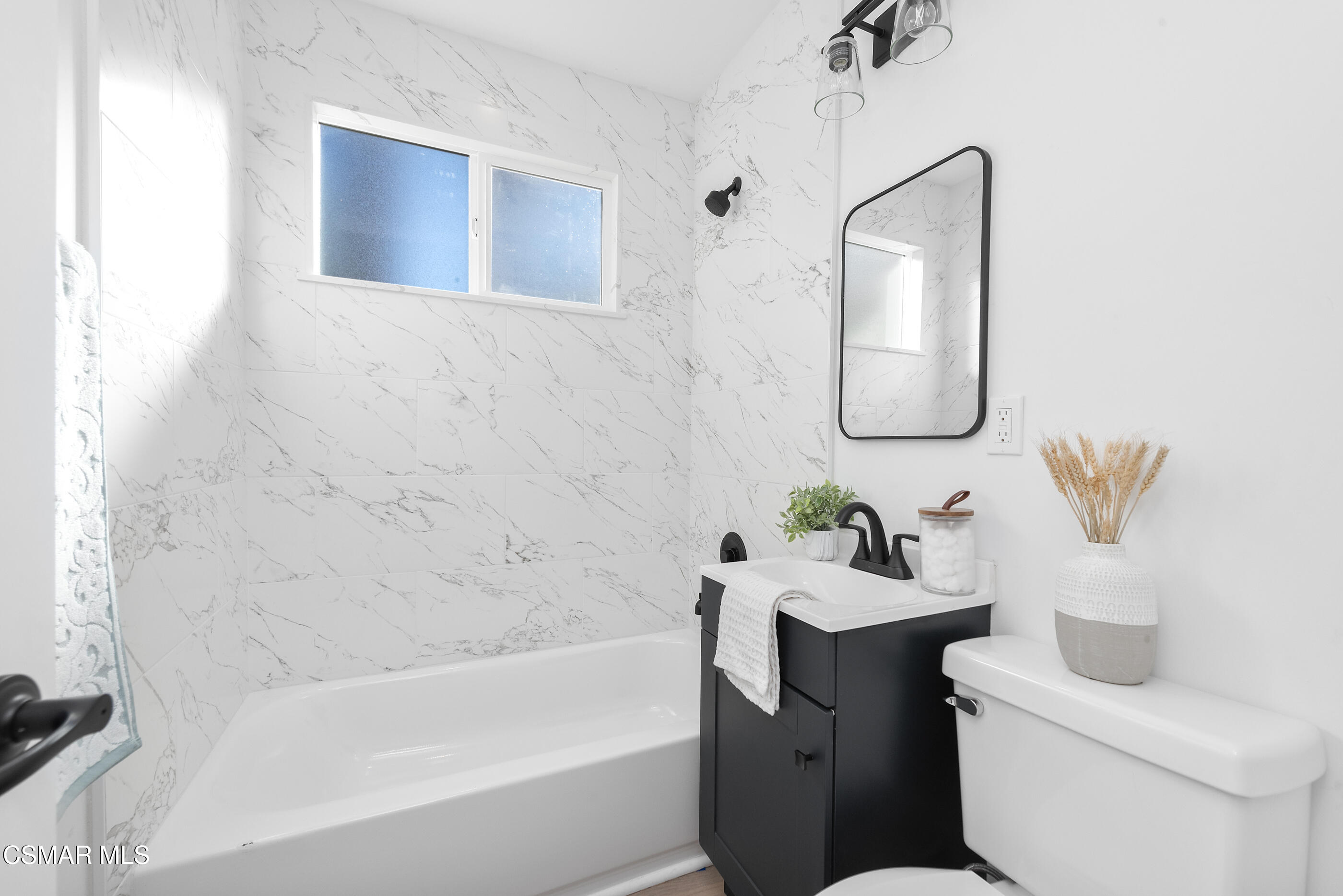3942 Hitch Boulevard Moorpark, CA 93021 - Photo 12 of 42 a bathroom with a bathtub sink vanity mirror and toilet