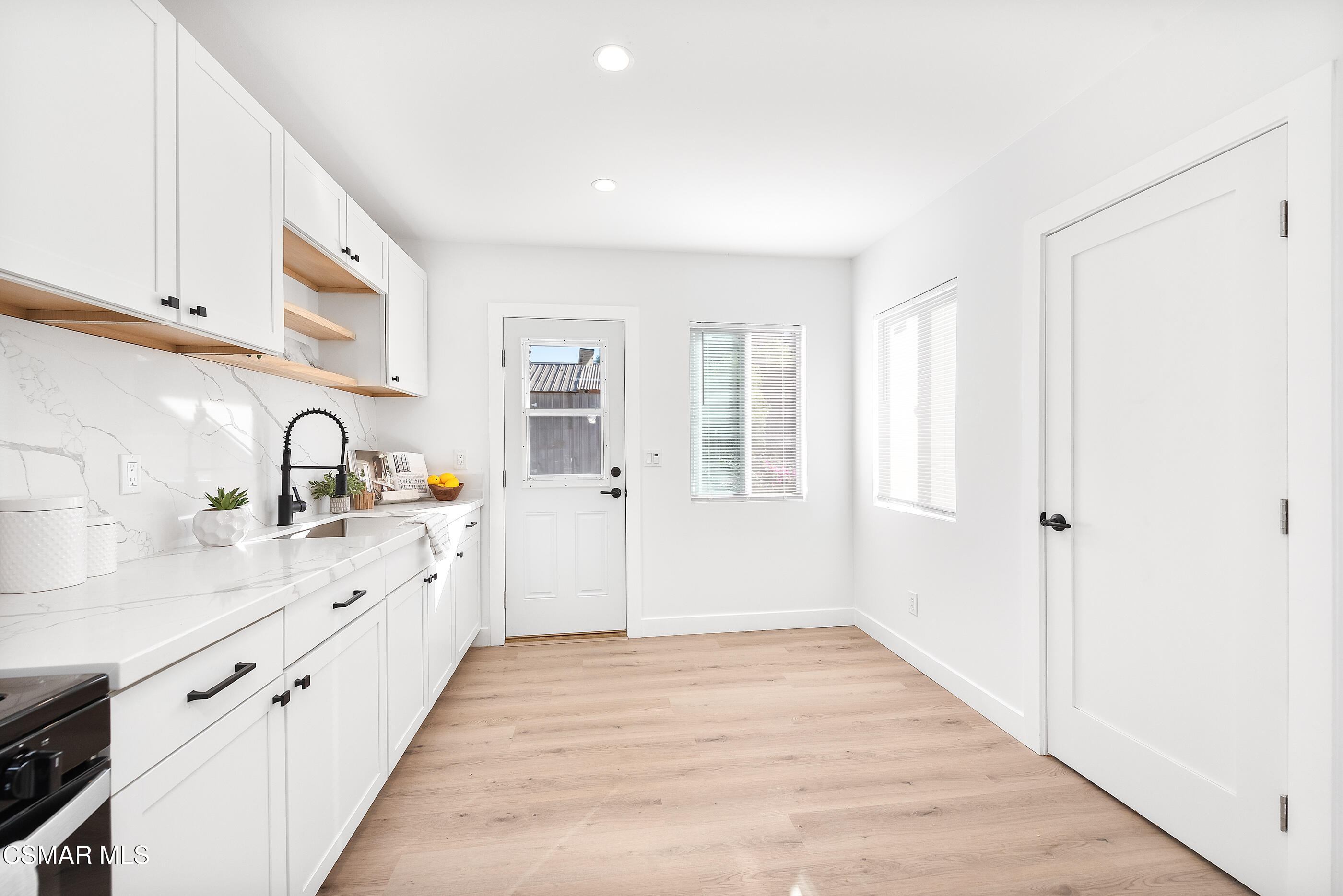 3942 Hitch Boulevard Moorpark, CA 93021 - Photo 5 of 42 a large white kitchen with white cabinets and sink