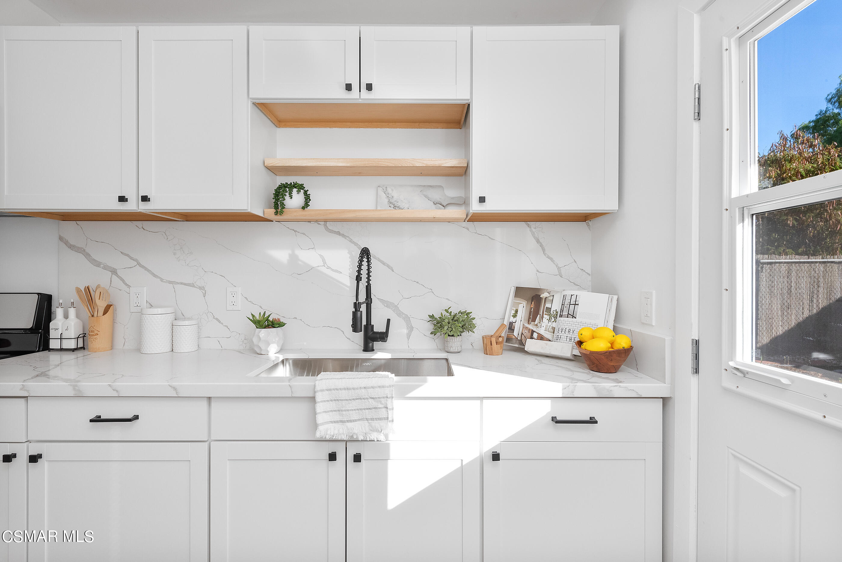 3942 Hitch Boulevard Moorpark, CA 93021 - Photo 7 of 42 a kitchen with white cabinets and a sink