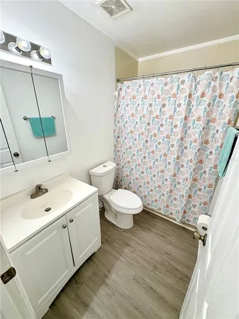 a bathroom with a sink a toilet and a mirror
