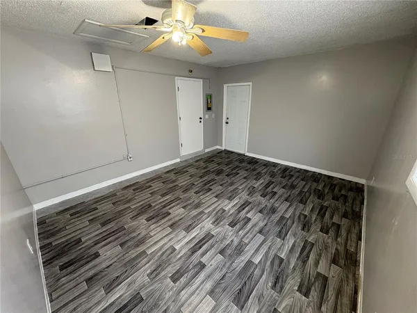 a view of a room with wooden floor