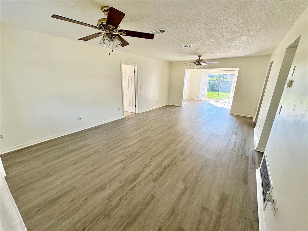 5389 Mariner Boulevard Spring Hill, FL 34609 - Photo 4 of 17 wooden floor in an empty room with a window
