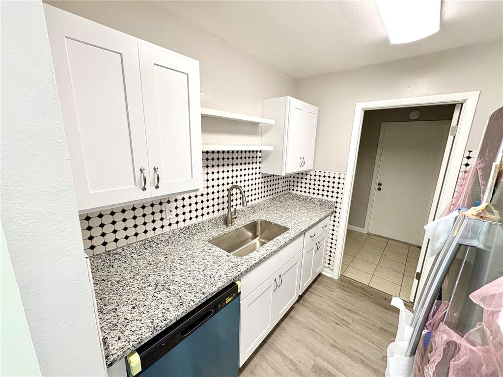 5389 Mariner Boulevard Spring Hill, FL 34609 - Photo 7 of 17 a bathroom with a granite countertop sink and a mirror