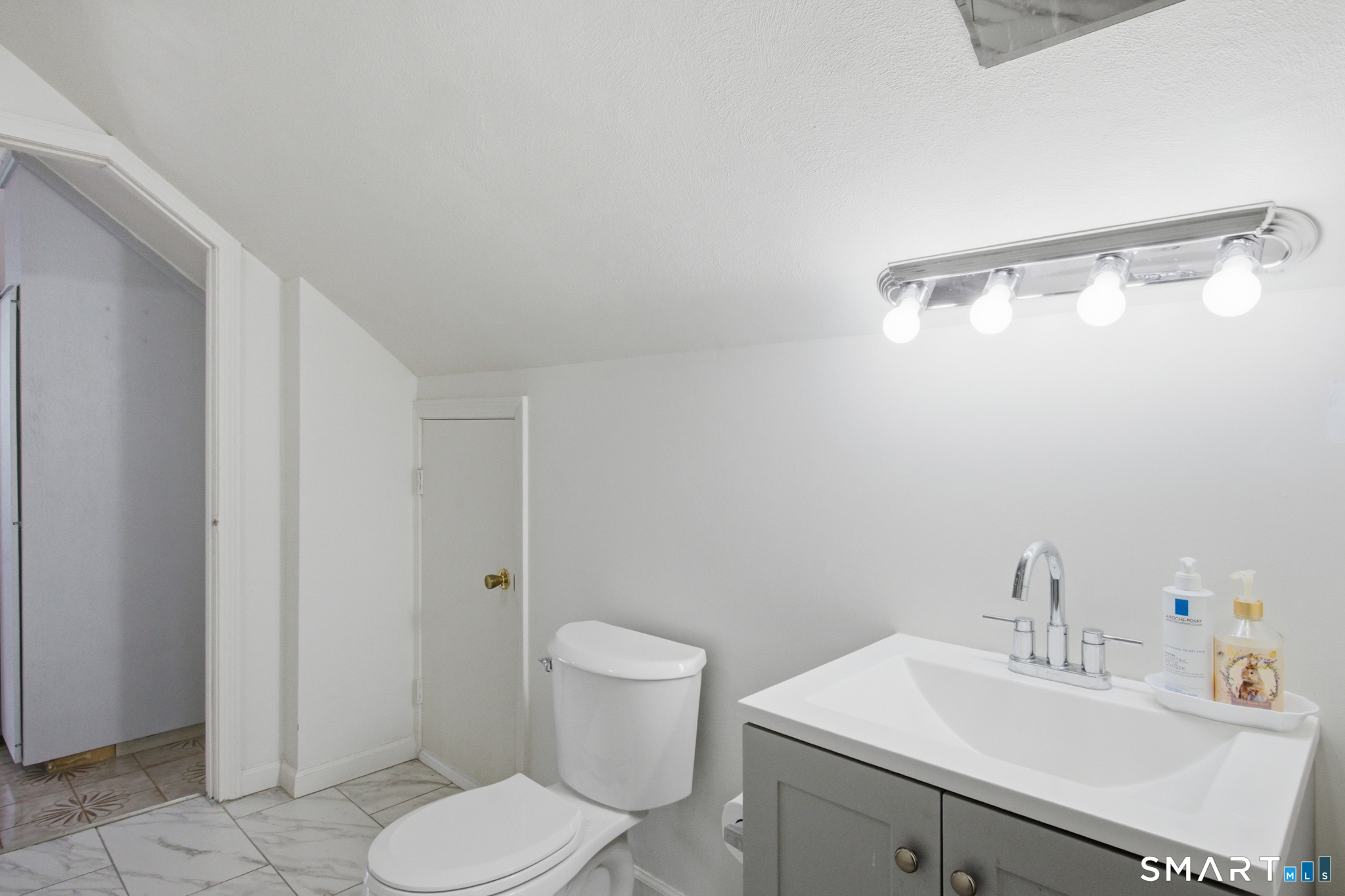 590 North Walnut Street Waterbury, CT 06704 - Photo 19 of 37 a bathroom with a sink mirror vanity and toilet