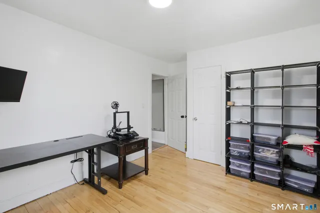 a view of a workspace with furniture and wooden floor