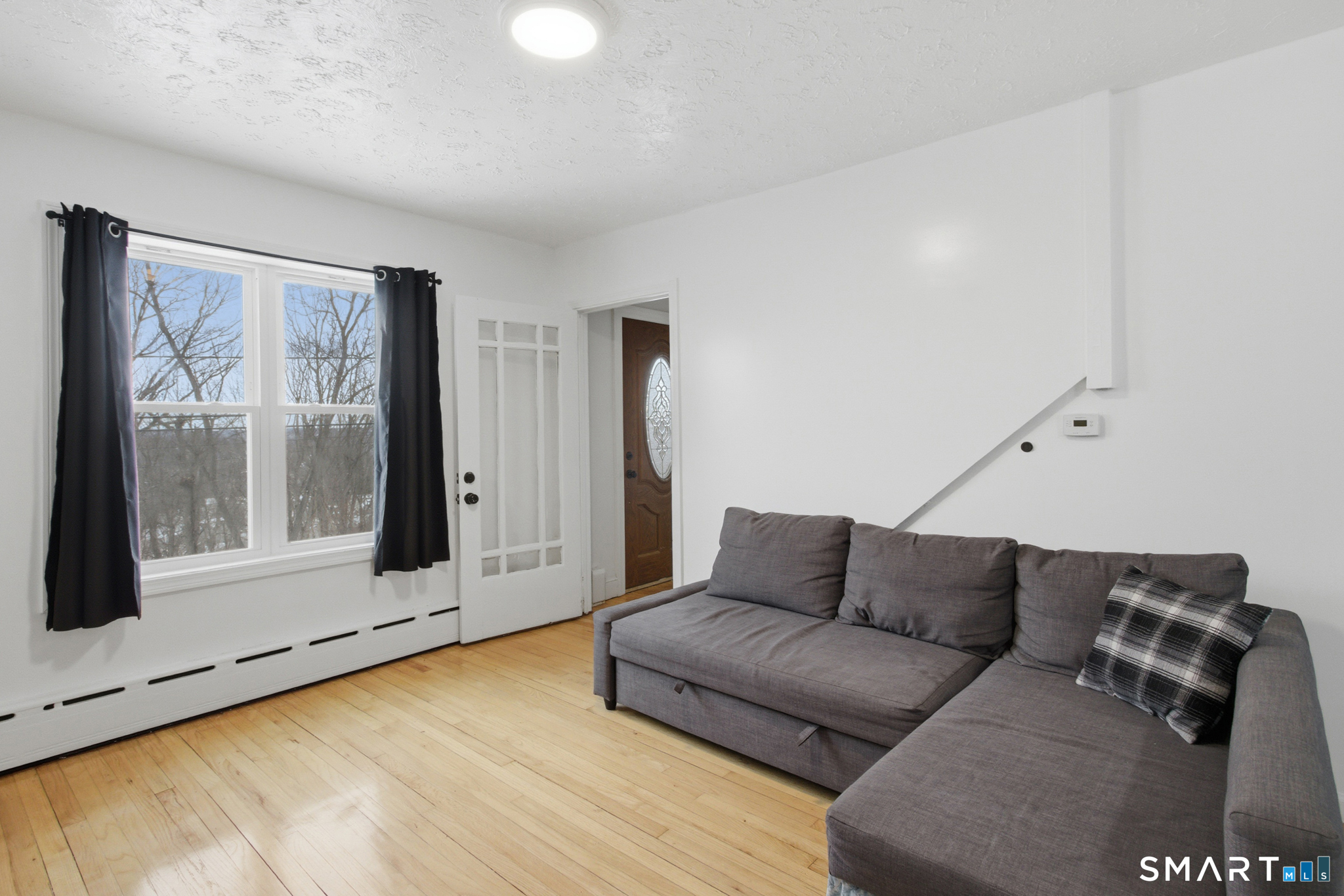 590 North Walnut Street Waterbury, CT 06704 - Photo 5 of 37 a living room with furniture and a window