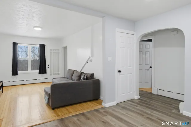 a living room with a couch and a rug