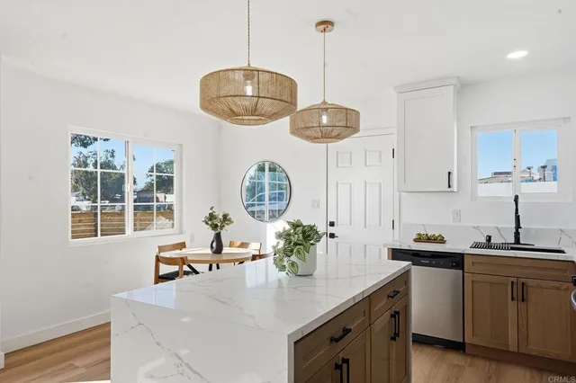 a kitchen with a sink a counter space appliances and cabinets