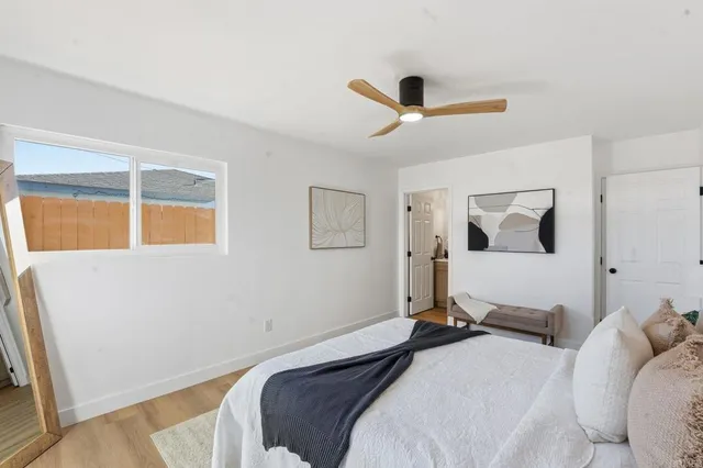 a bedroom with a bed and a window