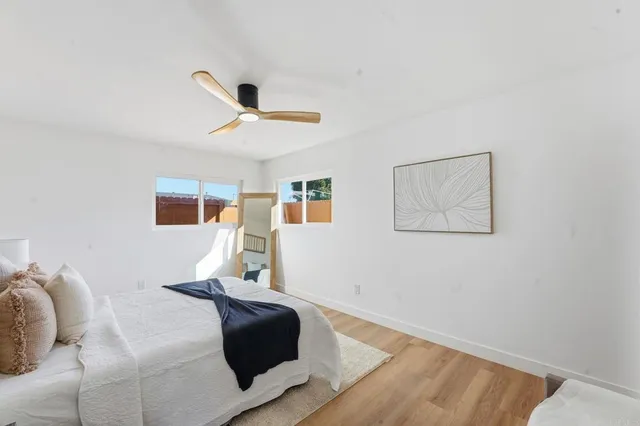 a bedroom with a bed and wooden floor