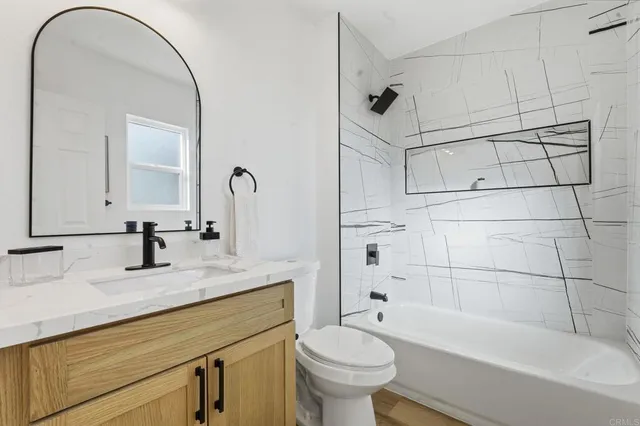 a bathroom with a sink a toilet and bathtub