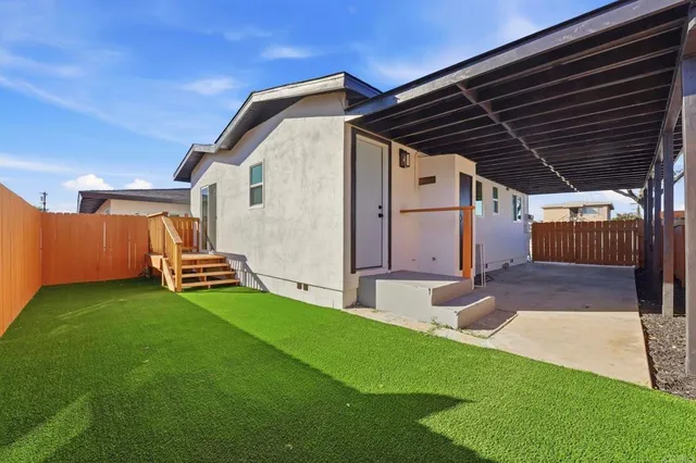 a view of a livingroom with furniture and a kitchen