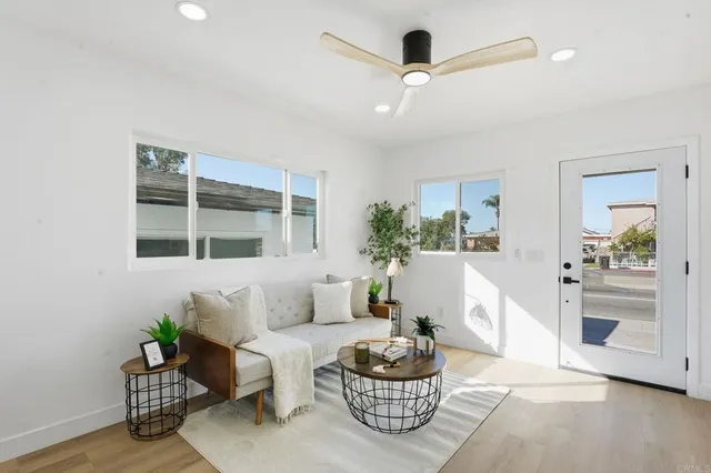 a living room with furniture and wooden floor