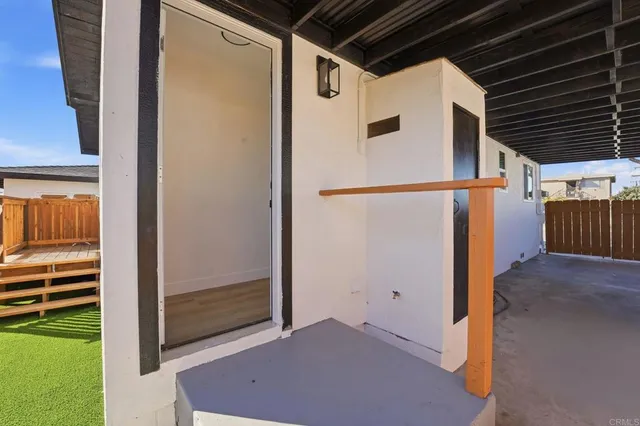 an aerial view of a city with lots of residential buildings ocean and mountain view in back