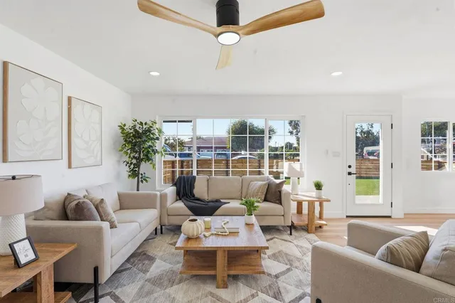 a living room with furniture a lamp and a chandelier