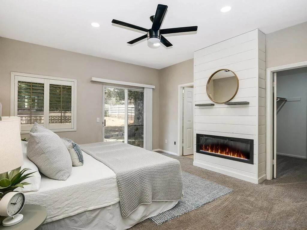 16304 Dartolo Road Ramona, CA 92065 - Photo 17 of 36 a bedroom with a bed and a fireplace