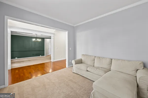 a view of a room with a chandelier fan and windows