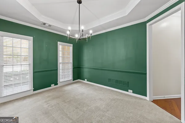 an empty room with closet and a chandelier fan
