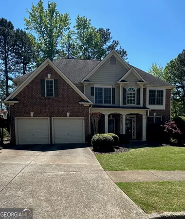 a front view of a house with a garden