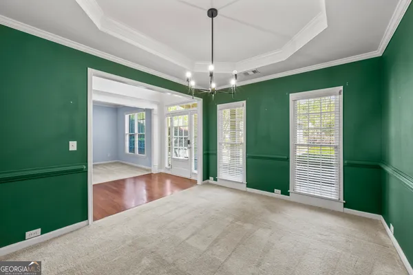 a view of an empty room with window and cabinet