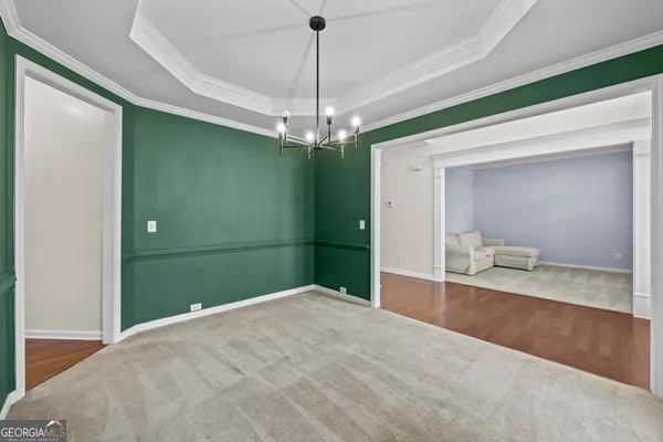 an empty room with windows and fireplace