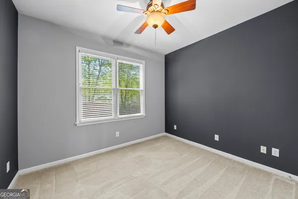 a dining room with wooden floor a chandelier a wooden table and chairs