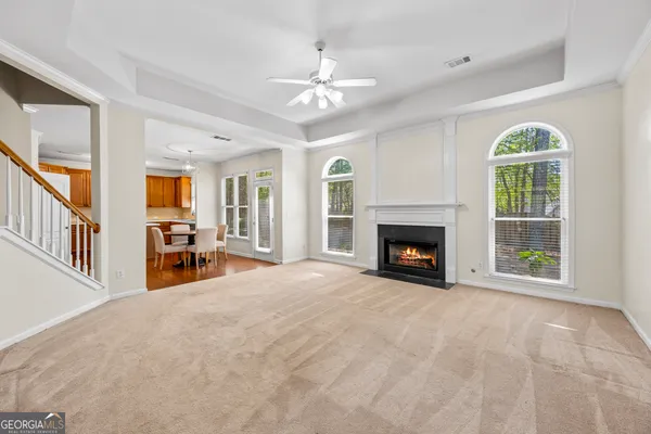 a kitchen with stainless steel appliances granite countertop a stove a sink dishwasher and a refrigerator with wooden floor