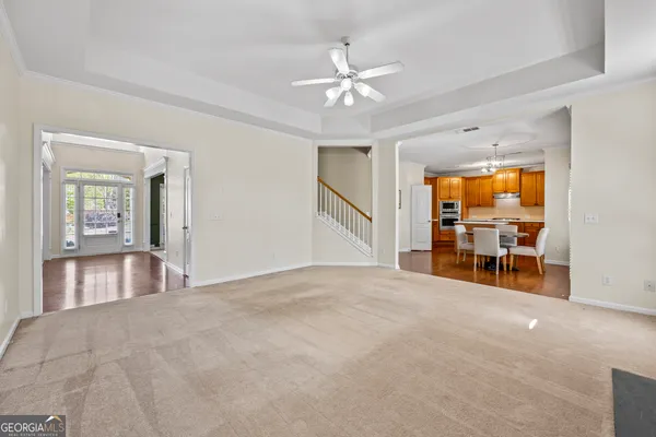 a view of a hallway with windows and chandelier