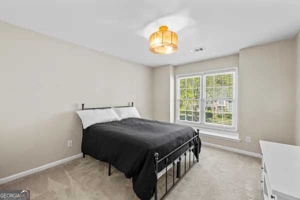 a view of a livingroom with an empty space and a window