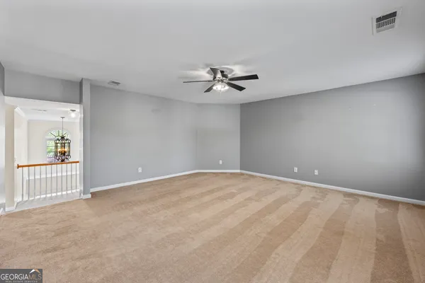 a white toilet sitting next to a white cabinet