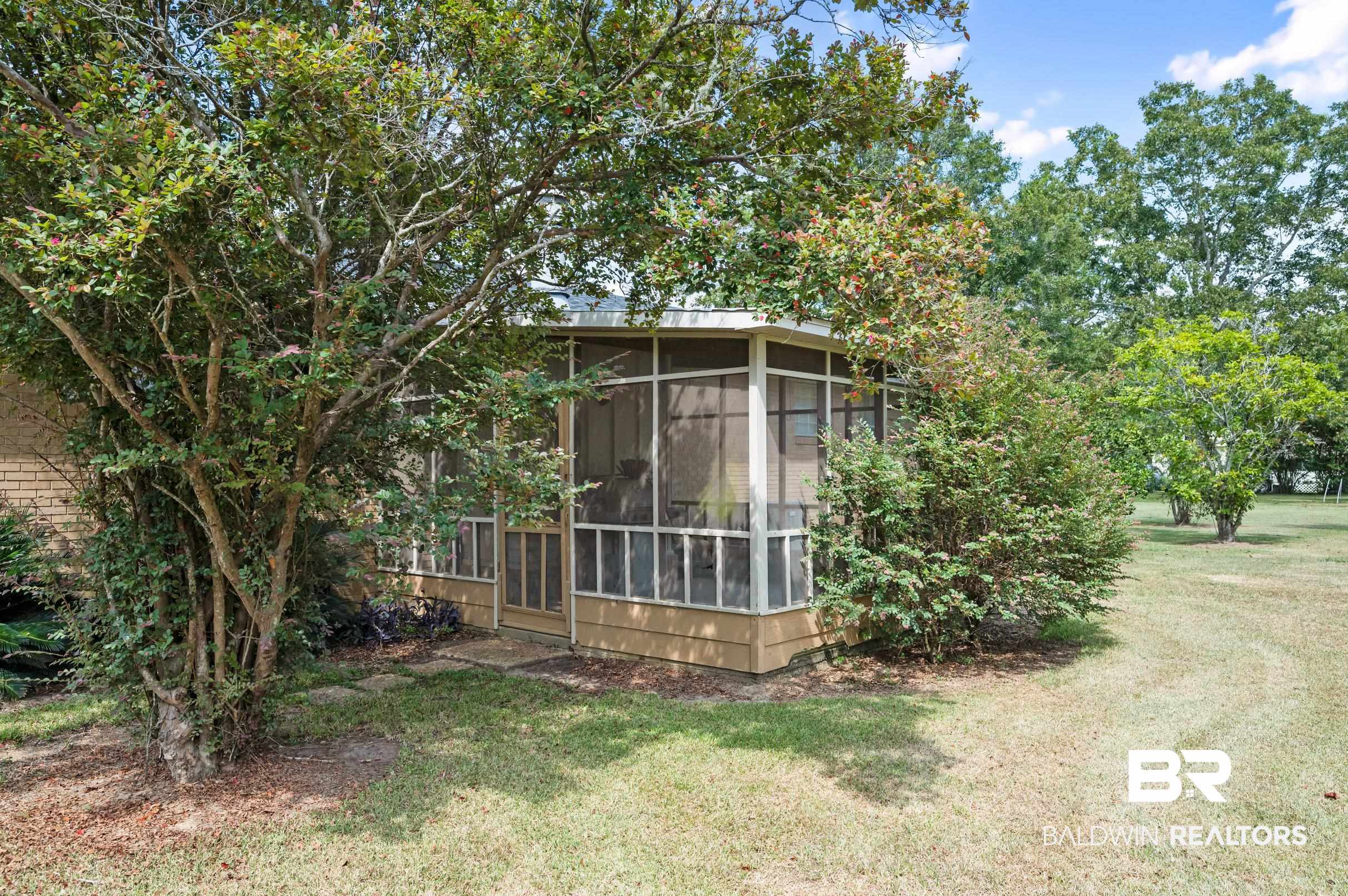 15600 Fackler Road Loxley, AL 36551 - Photo 40 of 51 Exterior space with a sunroom and a front lawn