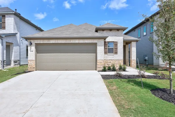 a front view of a house with a yard and garage